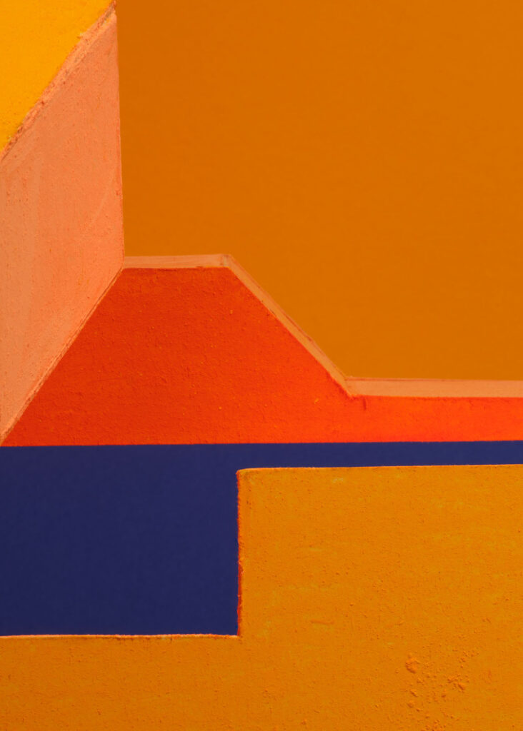 abstract colour study with geometric plaster forms in orange, pink, blue and yellow exploring shifting colour relationships and spatial perception