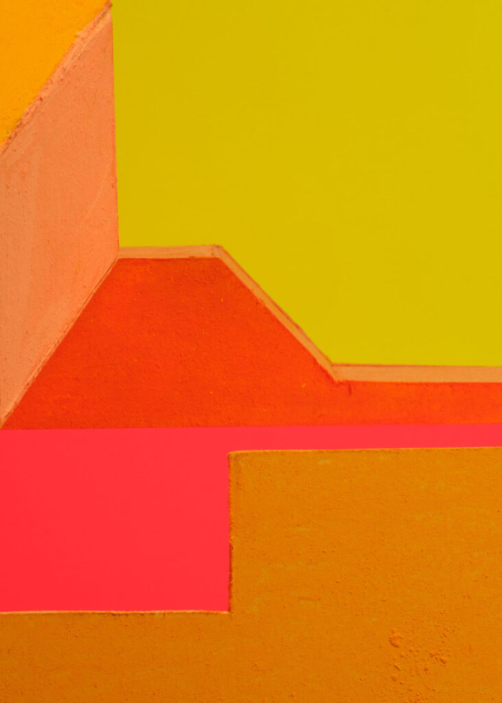 abstract colour study with geometric plaster forms in orange, pink, blue and yellow exploring shifting colour relationships and spatial perception