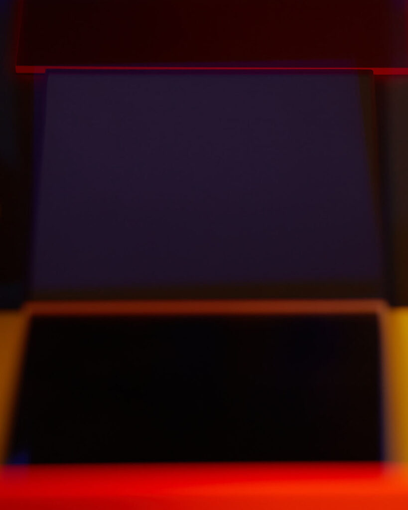 abstract photograph of plexiglass surfaces and reflected red light
