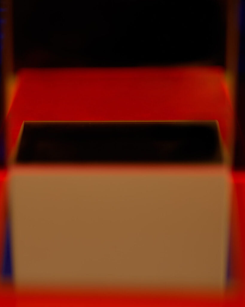 abstract photograph of plexiglass surfaces and reflected red light
