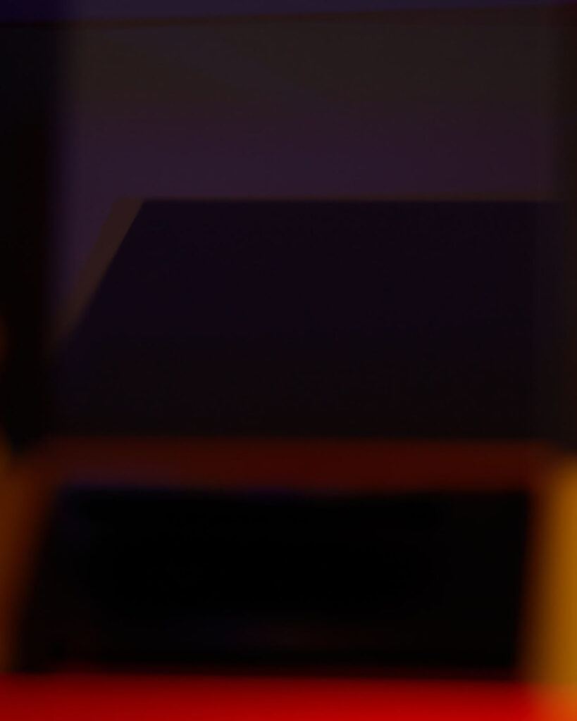 abstract photograph of plexiglass surfaces and reflected red light