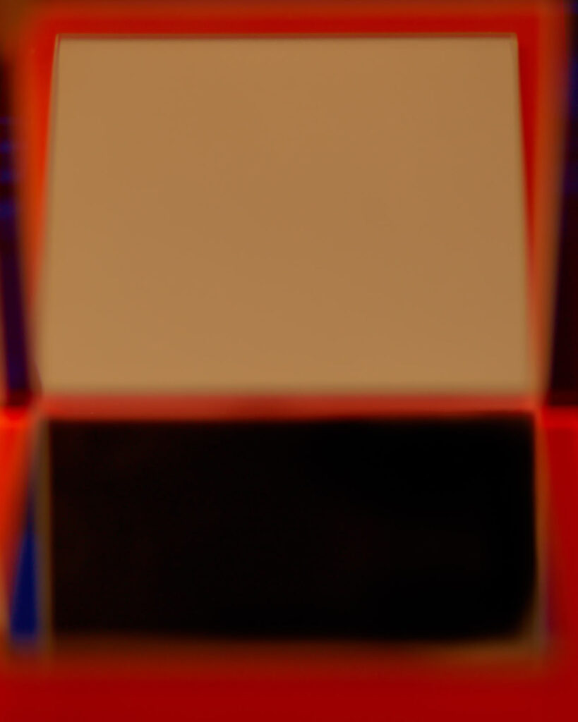 abstract photograph of plexiglass surfaces and reflected red light